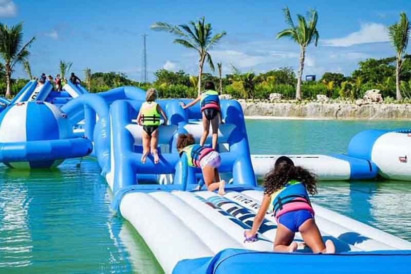 children having fun on inflatable floating island - Punta Cana