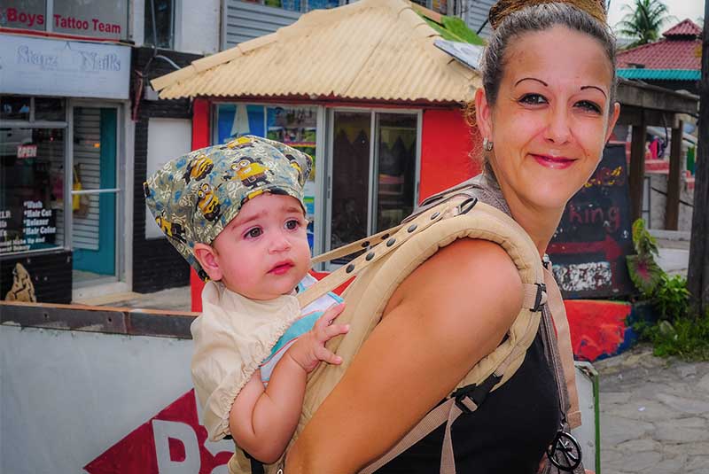 women with baby in carrier- Dominican Republic